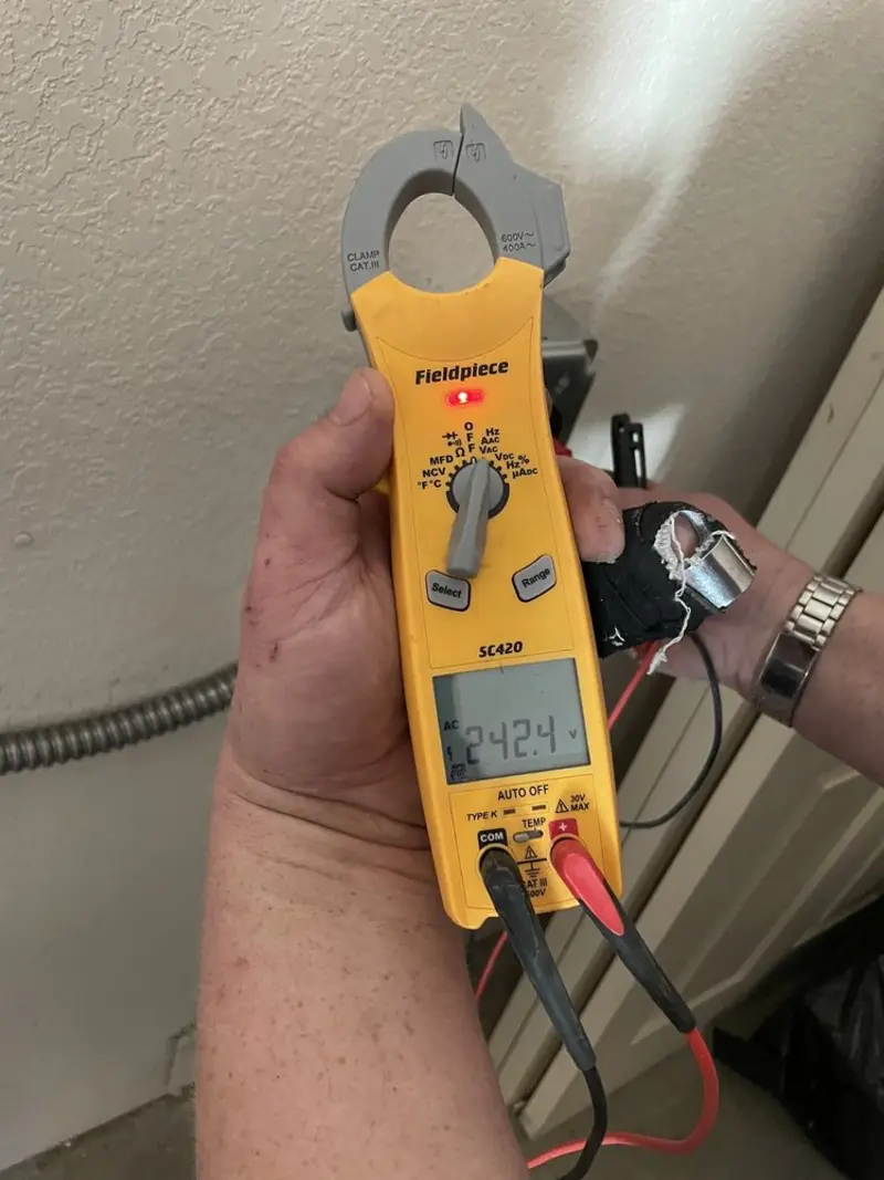 Voltage testing with clamp meter during Recessed Lighting Installation in Richwood